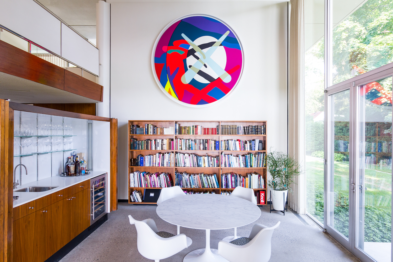 A large-scale tondo by KAWS’ hung above the bookcase, photo by Alessandra Ferrara, courtesy of Library Street Collective.