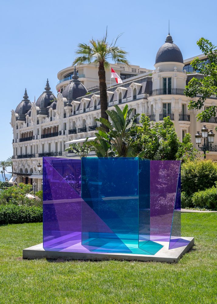 Larry Bell, “The Blue Gate,” 2021, Peacock and Amethyst laminated non-tempered glass, 182.9 x 243.8 x 243.8 cm; Installation view, ‘Larry Bell: Works from the 1970s’ at Hauser & Wirth Monaco, until 31 August 2024, © Larry Bell, Courtesy the artist and Hauser & Wirth, Photo: Nicolas Brasseur.