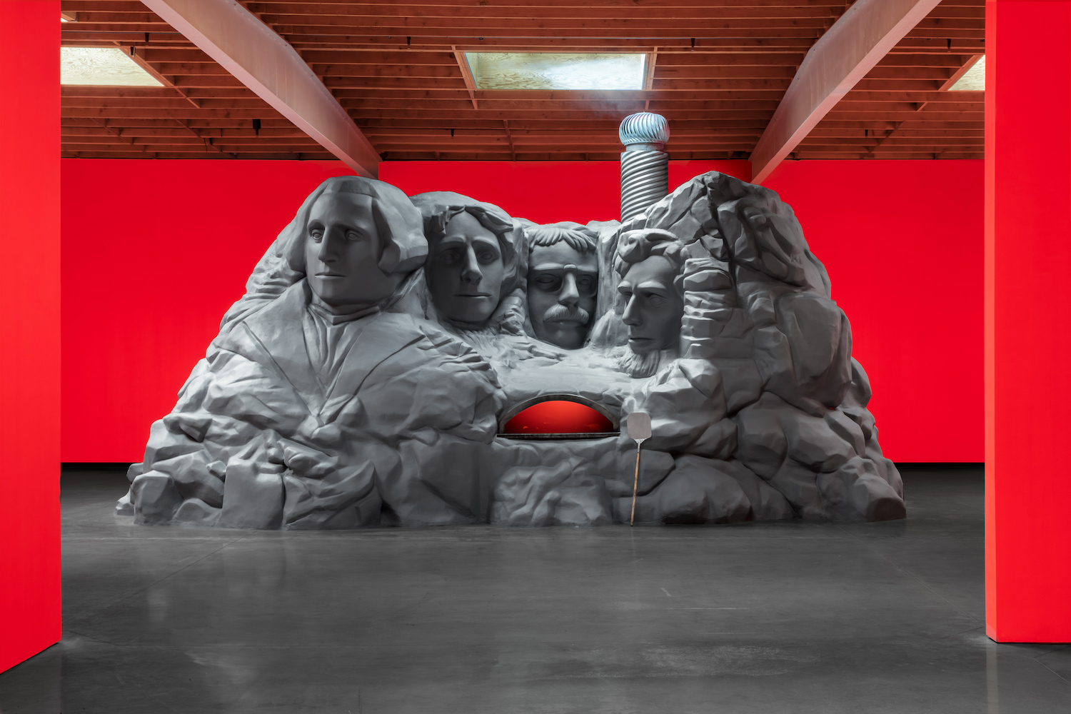 Eli Russell Linnetz, “Mount Rushmore Pizza Oven,” 2024, Concrete, plaster, wood, steel, foam, paint and electric flame, Approximately 15 x 32 x 14 feet. Courtesy of Jeffrey Deitch.