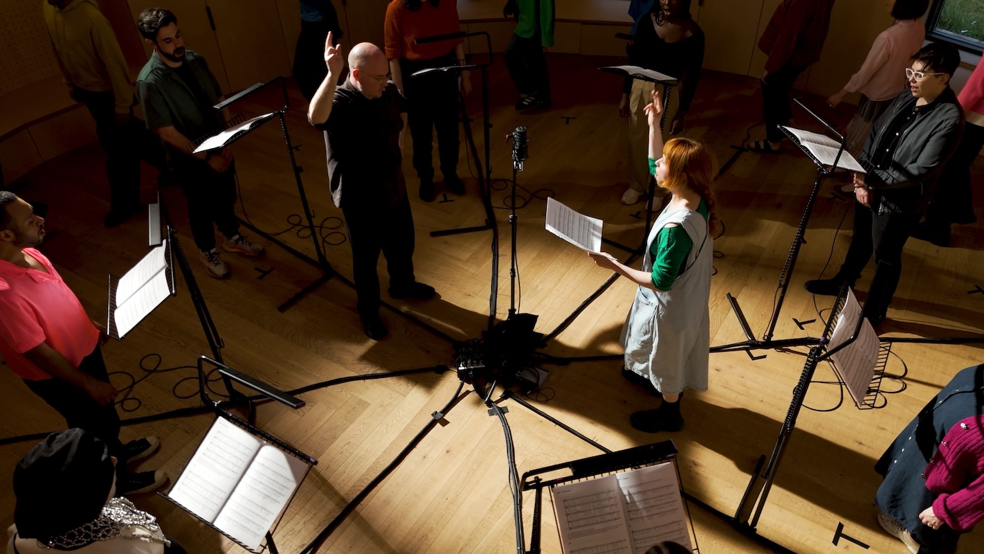 Holly Herndon and Mat Dryhurst conducting a recording session with London Contemporary Voices in London, 2024