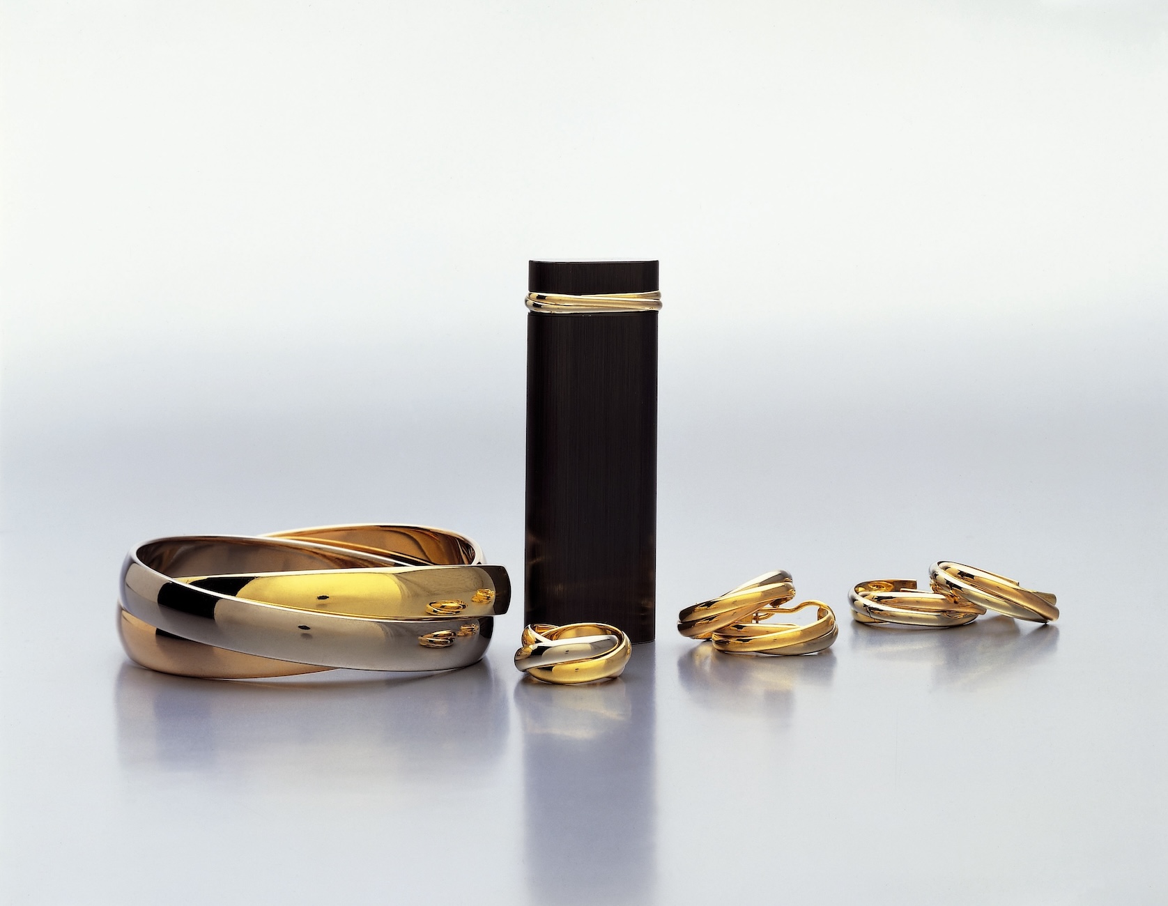 Trinity collection: bracelet, earrings and three-band rings, three-band lighter, 1982,